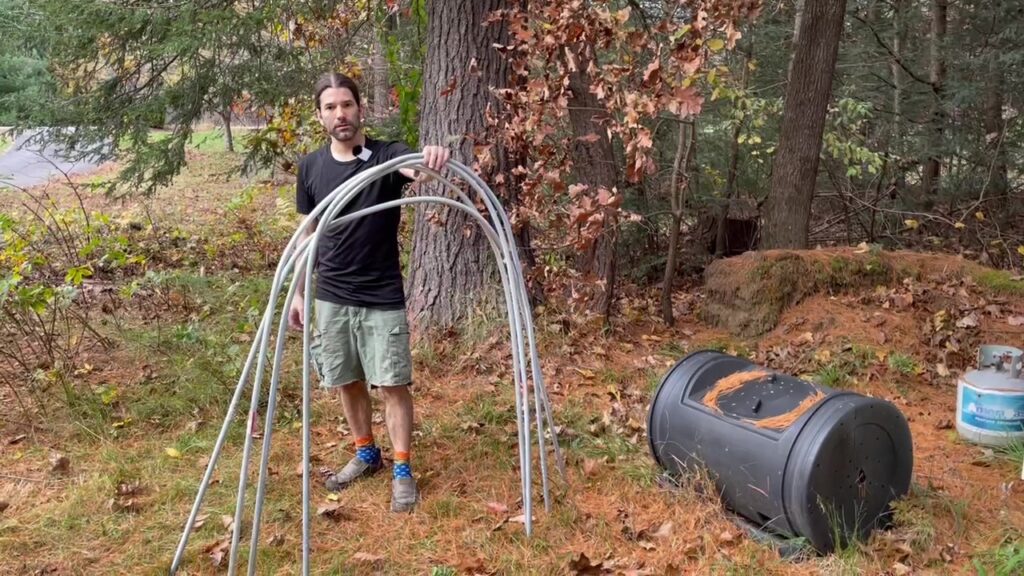 Holding a set of curved sections of aluminum conduit to be used as hoops to support the winter garden mini greenhouses.