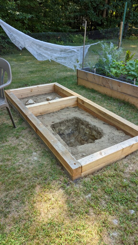 Garden pond is dug and framed with cedar posts